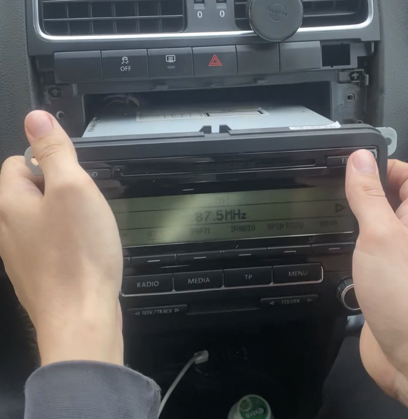 Step 2: Unscrew and remove old radio